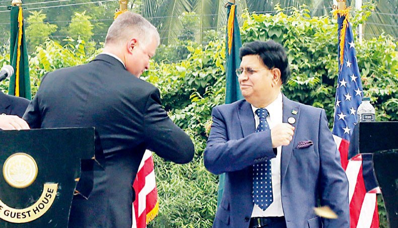 Bangladesh’s foreign minister AK Abdul Momen gives US deputy secretary of state Stephen Biegun an elbow greeting during a meeting in Dhaka on October 15. — New Age/Sourav Lasker