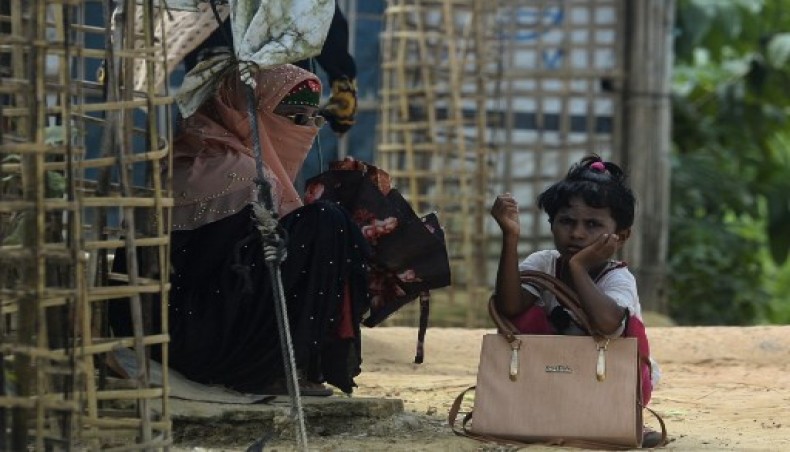 A Rohingya refugee girl waits for transportation with her mother at Kutupalong refugee camp in Ukhia on October 15, 2020.- AFP photo