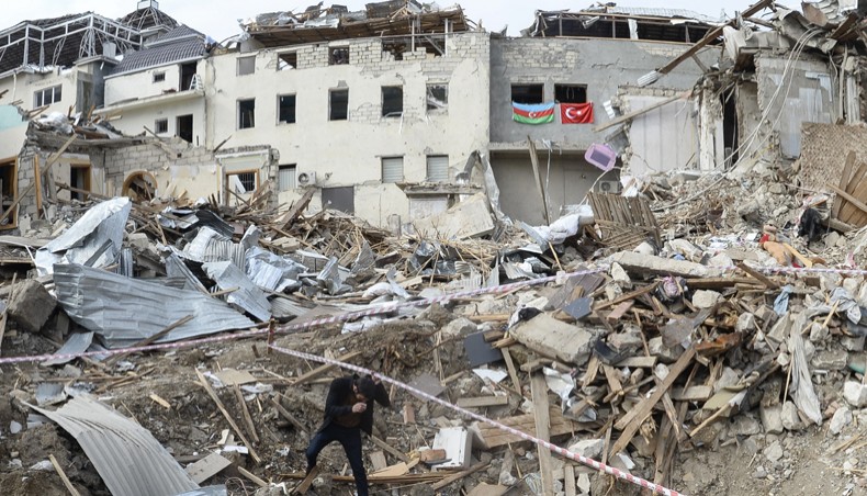A man walks among the debris of destroyed buildings hit by shelling during the ongoing military conflict between Armenia and Azerbaijan over the breakaway region of Nagorno-Karabakh, in a residential area of the city of Ganja, Azerbaijan, on October 22. — Agence France-Presse/Tofik Babayev