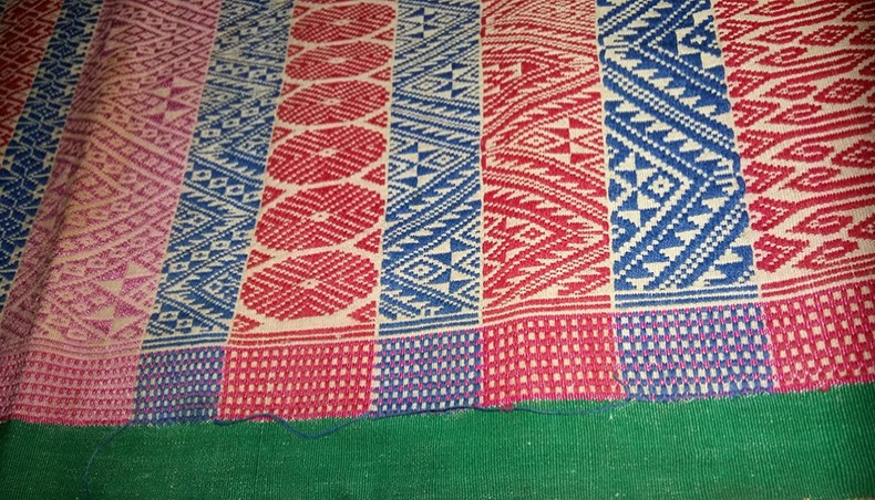 Photo from an aalaam, with 115 patterns, weaved by Shrimati Charumati Khisa of Sabekhong in1952. Shrimati Khisa, the daughter of the late Krishna Mohan Khisa and Shoroshi Bala Khisa, was born on August 23, 1939 at Sabekhong village of Naniachar in a wealthy mahajan household of the Chittagong Hill Tracts. In 1963, she moved to the present Rangamati town, with her husband Chandra Shekhar Khisa and their children, after their old Rangamati town home went under the Kaptai lake. — Kabita Chakma