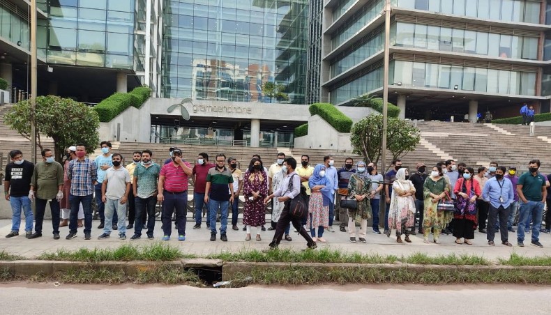 A section of employees of telecom operator Grameenphone form a human chain in front of its headquarters in the city on Wednesday. — New Age photo