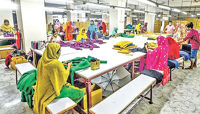 A file photo shows workers sewing clothes in a readymade garment factory on the outskirts of Dhaka. Almost 80 per cent of households in the country experienced a significant reduction in income amid the coronavirus outbreak, according to a survey report. — AFP photo