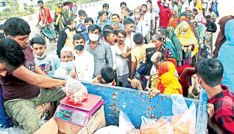 People in a long queue buy commodities from an OMS truck of TCB on Abdul Gani Road beside Secretariat in Dhaka on Wednesday. — Sony Ramany