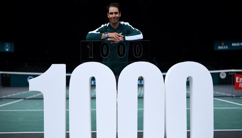 Spain's Rafael Nadal celebrates as he receives the trophy of his one thousandth victory of the ATP at the end of his men's singles second round tennis match against Spain's Feliciano Lopez in Paris on Wednesday. — AFP photo