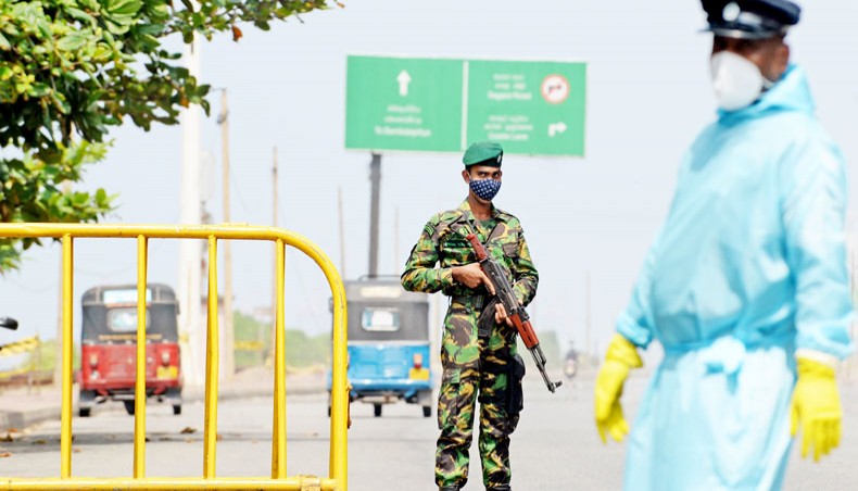 Security personnel guard a road checkpoint in Colombo on November 2 following a one-week curfew extension for the Western province to contain the spread of the coronavirus. — Agence France-Presse/Lakruwan Wanniarachchi