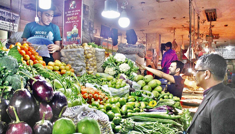 A vendor sells vegetables at a shop at Segun Bagicha in the capital on Friday. Prices of most essential commodities, including rice, remained high on the kitchen markets in the city over the week ending on Friday. — Focusbangla photo