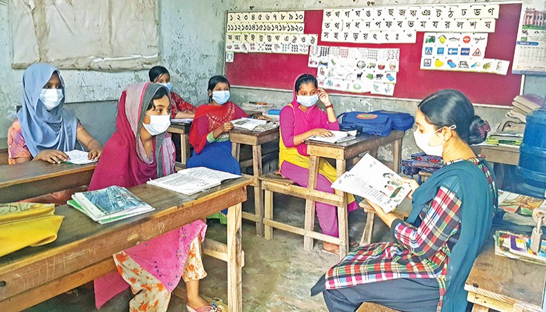 A teacher gives tuition to a few students who do not have access to online learning at Hazaribagh in Dhaka recently. — New Age photo