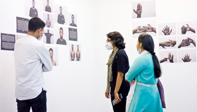 Visitors look at artworks displayed at an on-going group art exhibition Art in Isolation at Kalakendra in Mohammadpur.— Press release