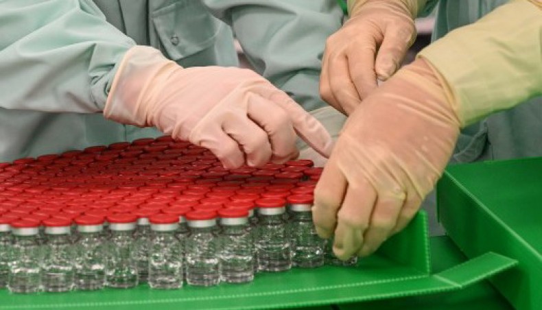 In this file photo taken on September 11, 2020 Laboratory technicians handle capped vials as part of filling and packaging tests for the large-scale production and supply of the University of Oxford’s COVID-19 vaccine candidate, - AFP file photo