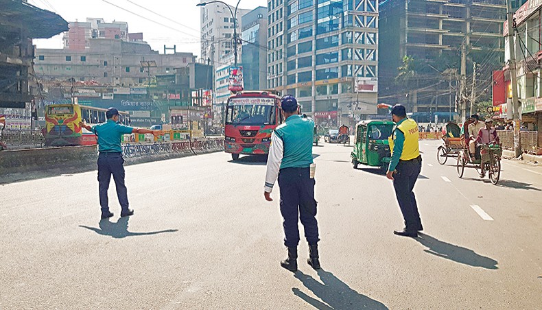 Police stop a bus at Kakrail in Dhaka on Friday to check it as vigilance was strengthened after 11 buses were torched on Thursday. — Sourav Lasker