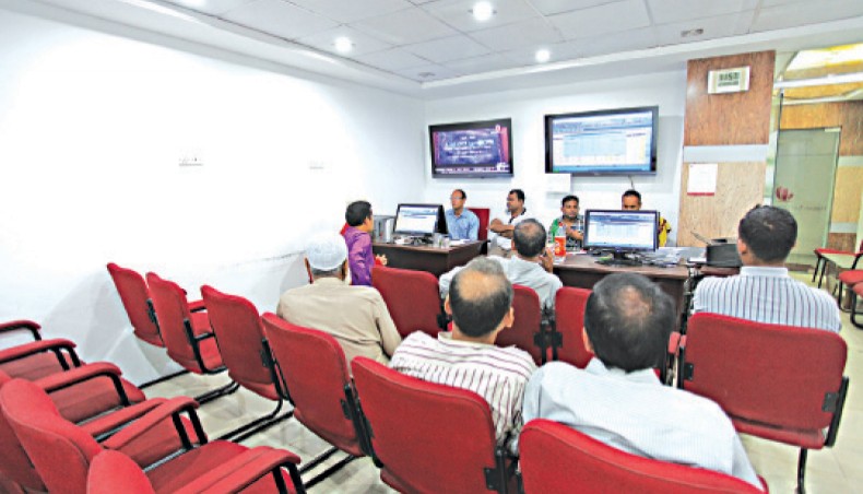 A file photo shows investors monitoring share price movements at a brokerage house in Dhaka. Dhaka stocks dropped in the past week as investors went for share sales ahead of the initial public offering subscription of the country’s second largest telecom company, Robi. — New Age photo