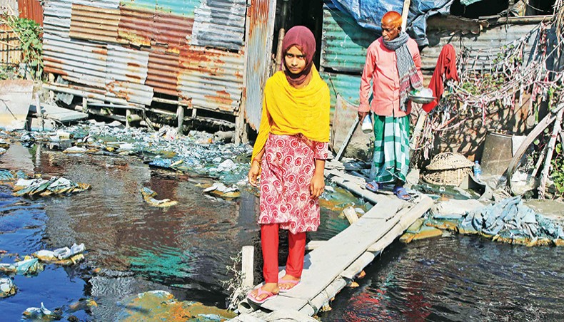 People cross a canal that takes industrial wastes and human sewage to the Buriganga multiplying environmental pollution and creating serious health hazards. This photo was taken at Baraitala of Shyampur in Dhaka on Sunday. — Sourav Lasker