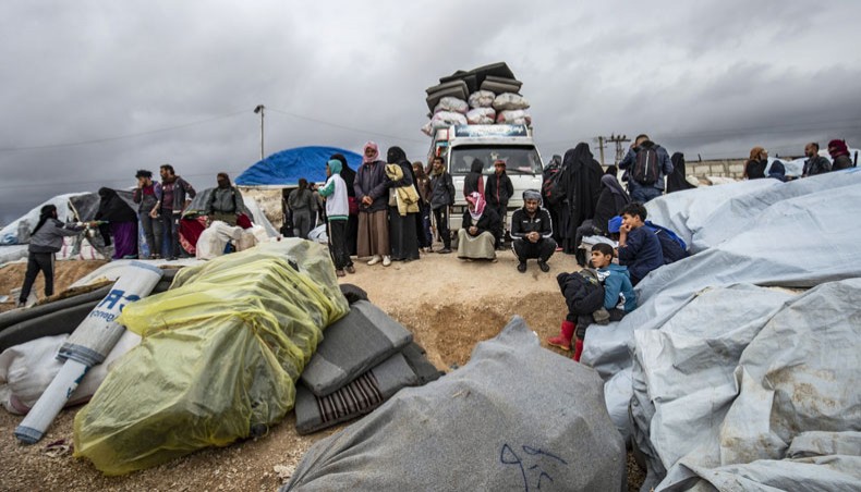 Syrians load their belonging onto trucks as they prepare to leave the Kurdish-run al-Hol camp holding relatives of alleged Islamic State group fighters, in the al-Hasakeh governorate in northeastern Syria, on Monday. — AFP photo