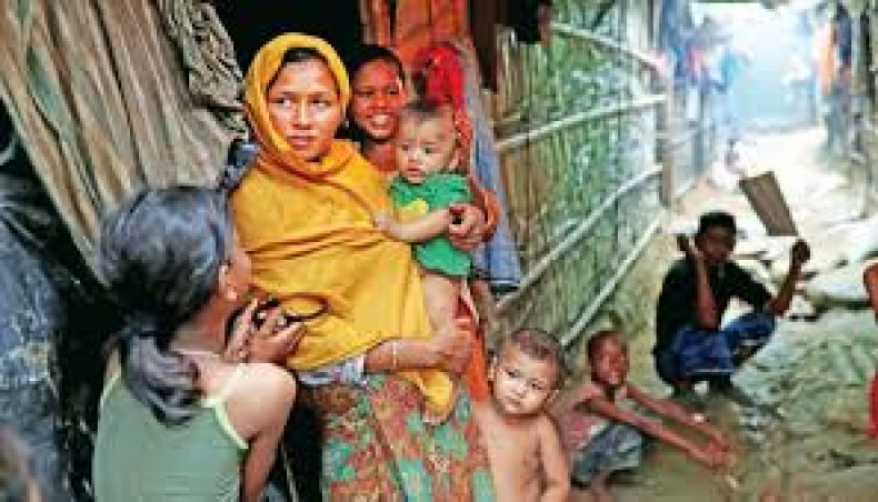 Rohingya refugees are seen outside of their makeshift tent in the Kutupalong camp in Cox’s Bazar on Friday. — Reuters photo