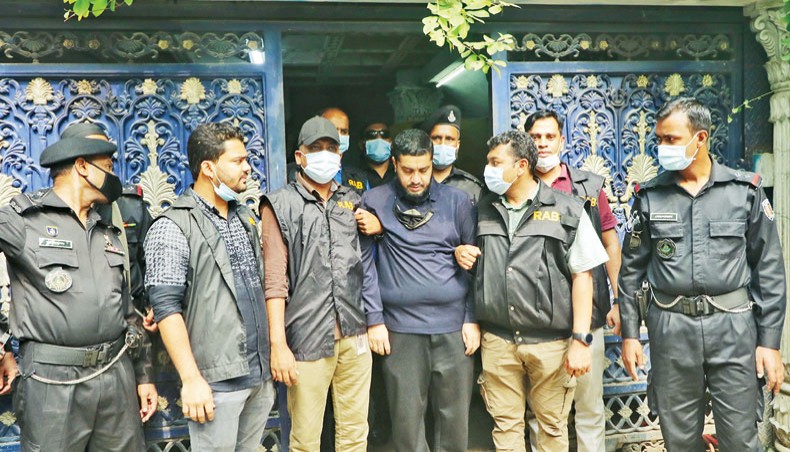 RAB arrests businessman Monir Hossain on charges of possessing illegal fire arms, drugs and a huge amount of gold and cash at his Merul Badda house in Dhaka on Saturday. — New Age photo