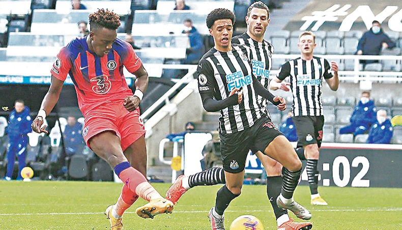 Chelsea striker Tammy Abraham (L) scores his team’s second goal during their Premier League match against Newcastle United at St James’ Park on Saturday. — AFP photo