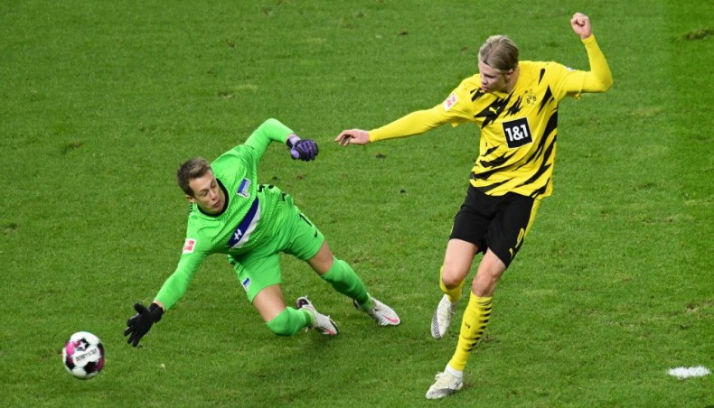 Dortmund forward Erling Braut Haaland (R) scores his team’s third goal past Hertha Berlin goalkeeper Alexander Schwolow during their Bundesliga match in Berlin on Saturday. — AFP photo