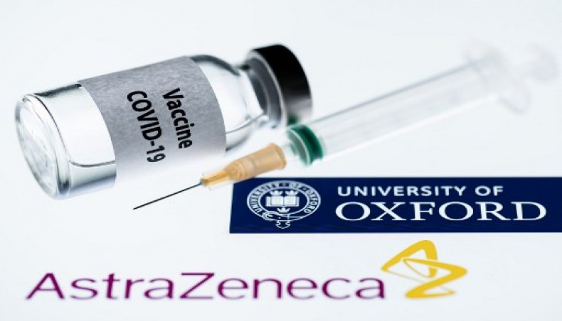 This illustration picture taken in Paris on November 23, 2020 shows a syringe and a bottle reading 'COVID-19 Vaccine' next to AstraZeneca company and University of Oxford logos.- AFP photo