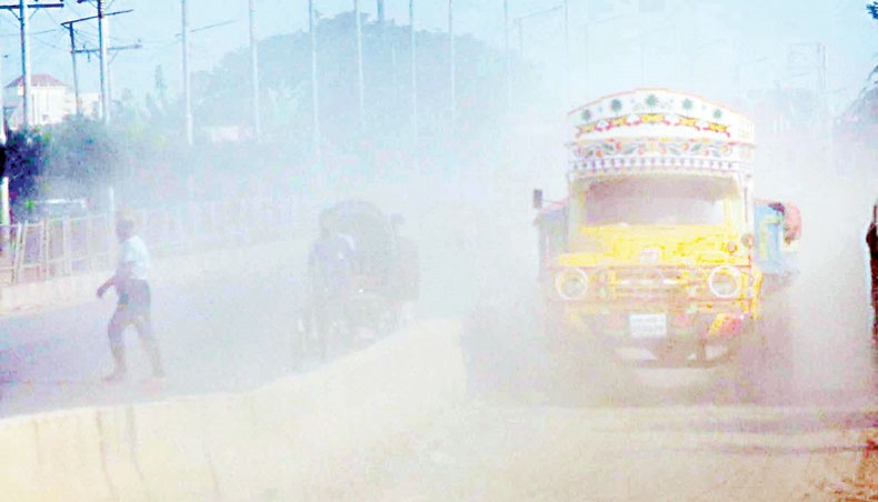 Dust shrouds a portion of the Dhaka-Aricha Highway at Amin Bazar in Dhaka on Monday. — Sony Ramany