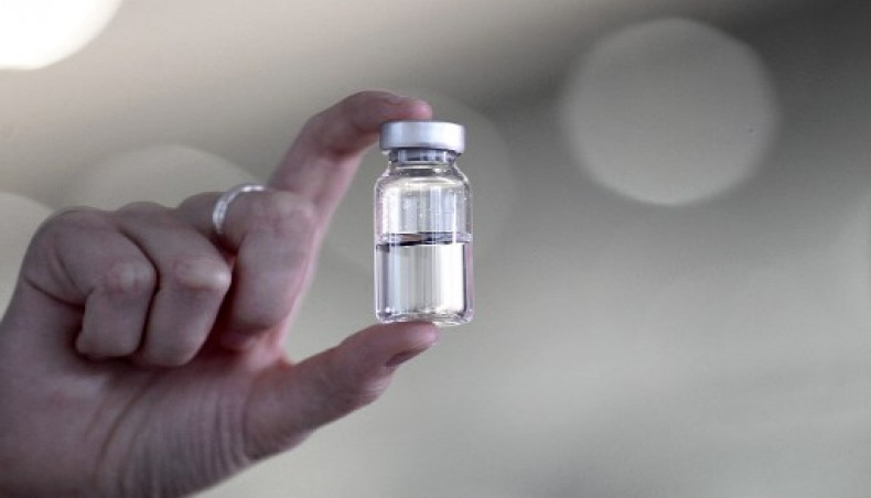 A woman holds a pharmaceutical vial of German glass company Schott at the company's headquarters in Mainz, western Germany, on November 20, 2020.- AFP photo