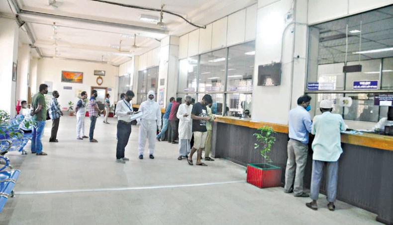 A file photo shows clients receiving services at a branch of a state-owned bank in the capital. Defaulted loans in the country’s banking sector would surge further as defaulters would now use the coronavirus outbreak as a pretext to not repay their bank debts on time.— New Age photo
