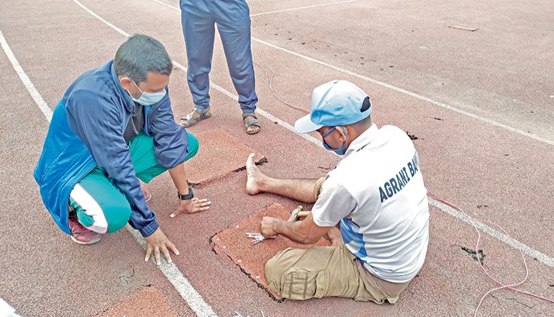 Workers renovate the damaged parts of the Bangabandhu National Stadium’s running track on Wednesday. — New Age photo