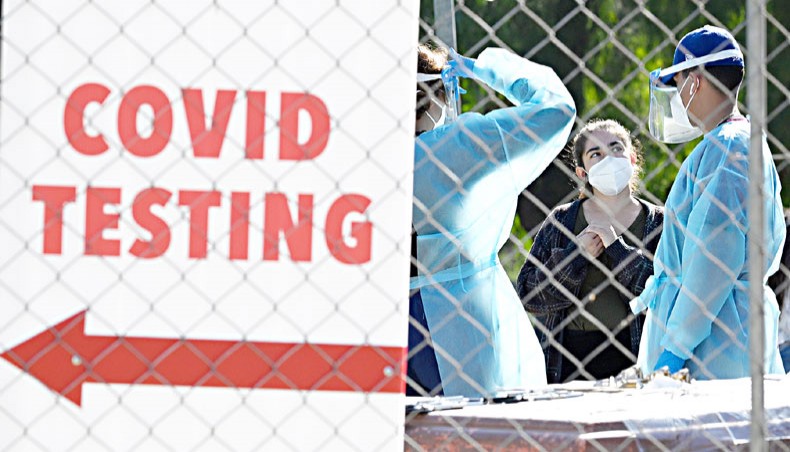 Healthcare workers are at a walk-up COVID-19 testing site in San Fernando, California on November 24. — Agence France-Presse/Robyn Beck