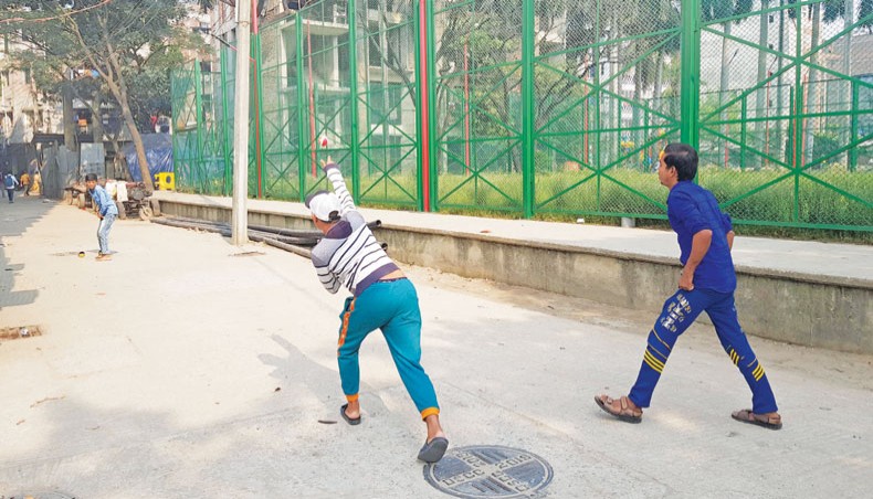 Children play cricket on a Hazaribagh road in Dhaka recently as a nearby playground has been kept closed for years. — Sourav Lasker