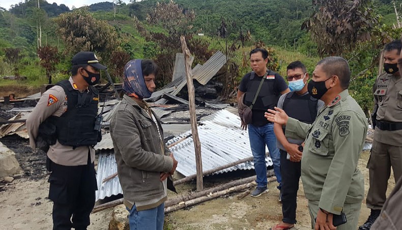 This handout photo taken and released on November 28, 2020, by the Central Sulawesi Province Police shows police officers inspect the site of an attack, believed to be by Islamic State-linked extremists, that killed four people in a remote Christian community of Lembantongoa village, in Palu on the Indonesian island of Sulawesi. — AFP Photo