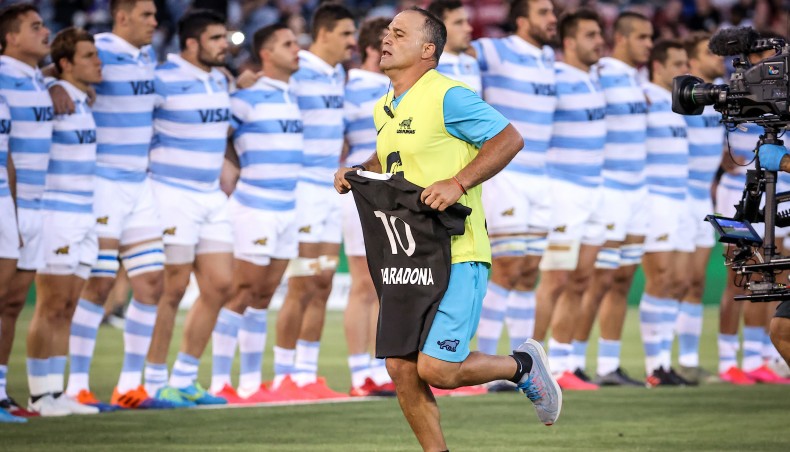 An official from the Argentina team carries an All Black’s jersey with the name Maradona and the number ten printed on it, as a tribute to the late Argentinian footballer, before the start of the 2020 Tri-Nations rugby match between New Zealand and Argentina at the McDonald Jones Stadium in Newcastle on Saturday. — AFP photo