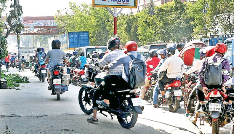Motorcyclists drive on footpaths flouting rules at Tejgaon in Dhaka on Sunday. — New Age photo