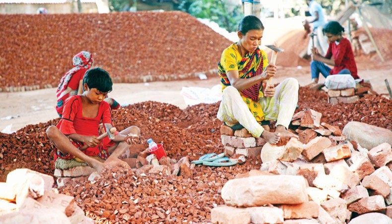 Minor girls break bricks at a brick breaking yard at Hasnabad of Keraniganj in Dhaka on Tuesday. — Sony Ramany