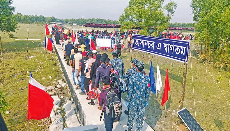Rohingya refugees stand in a queue after they disembarked from a Bangladesh Navy ship to Bashan Char in Hatiya on Friday. — AFP photo