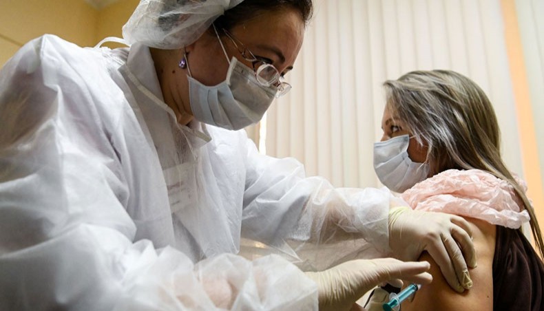 A nurse administers a dose of Sputnik V coronavirus vaccine to a woman at a clinic in Moscow on Saturday. - AFP photo