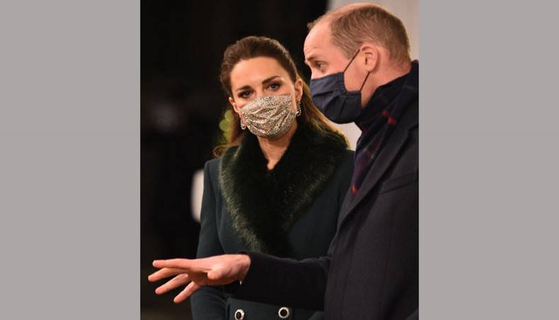 Britain's prince William, Duke of Cambridge, right, and Britain's Catherine, Duchess of Cambridge left, wearing protective face coverings to combat the spread of the coronavirus, attend an event to thank local volunteers and key workers for the work they are doing during the coronavirus pandemic and over Christmas in the quadrangle of Windsor Castle in Windsor, west of London, on December 8, 2020. — AFP