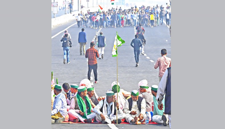 Farmers block a highway during a nationwide general strike called to protest against the recent agricultural reforms at the Delhi-Uttar Pradesh state border in Ghazipur on December 8. — Agence France-Presse/Prakash Singh