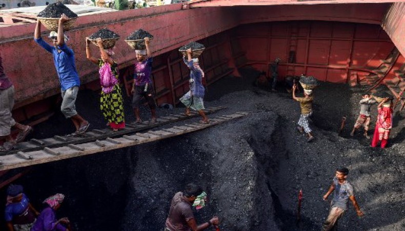 In this file photo taken on November 06, 2019 men an women unload coal from a cargo ship in Gabtoli on the outskirts of Dhaka.-AFP photo
