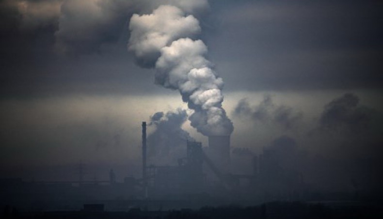 This file photo taken on January 23, 2020 shows a plant of German industrial conglomerate ThyssenKrupp (foreground) and smoke from a coal-fired power station in Duisburg, western Germany.