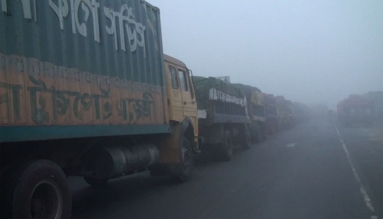 A 22 kilometres long traffic jam takes place from the eastern end of the bridge to Gharinda Underpass of Dhaka-Tangail-Bangabandhu Bridge Highway due to poor visibility caused by a heavy fog on Wednesday. — New Age Photo