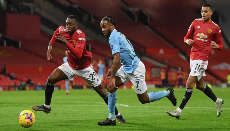 Manchester United defender Aaron Wan-Bissaka (L) vies with Manchester City midfielder Raheem Sterling (C) during their Premier League match at Old Trafford in Manchester on Saturday.— AFP photo