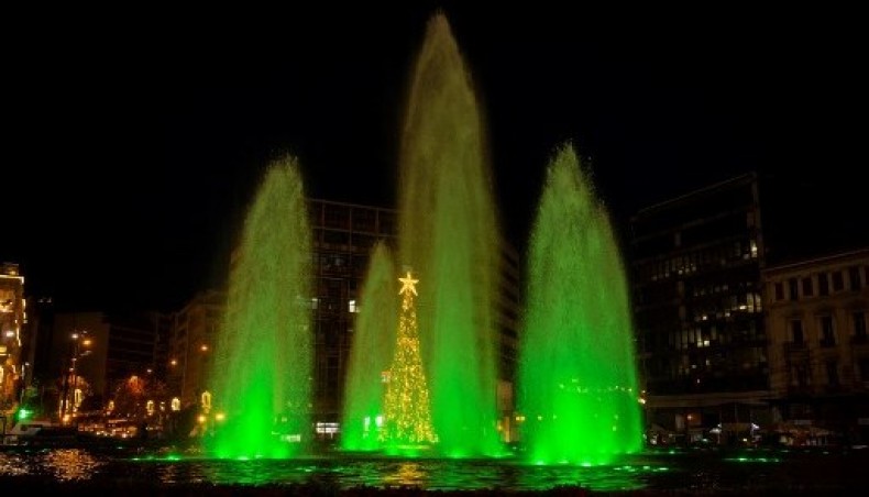 This photo taken on December 12, 2020 shows a fountain illuminated with green light at the Omonoia square in central Athens, to mark the 5th anniversary of the Paris climate accord.- AFP photo