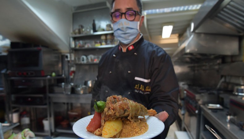 Tunisian chef Taieb Bouhadra presents a prepared traditional Tunisian lamb couscous dish at a restaurant in the Medina of Tunisia's capital Tunis on December 16, 2020. -- AFP photo