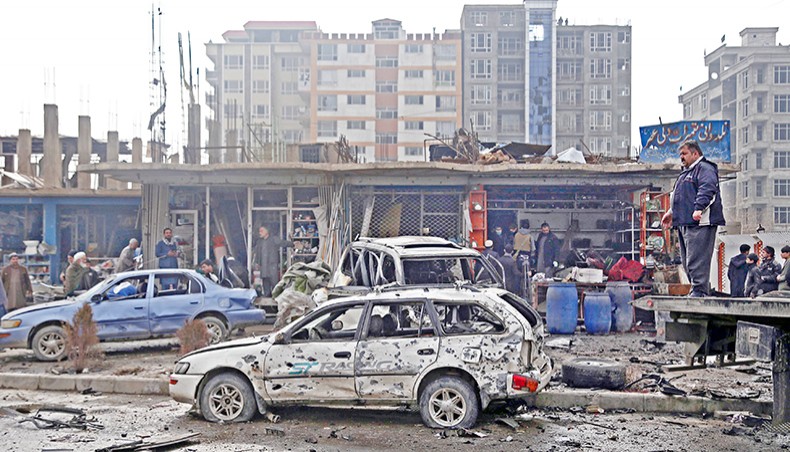Damaged cars are seen at the site of an attack in Kabul on Sunday. A car bomb targeting an Afghan lawmaker killed nine people and wounded more than a dozen in Kabul on December 20, officials said, the latest attack to rock the capital. — AFP photo