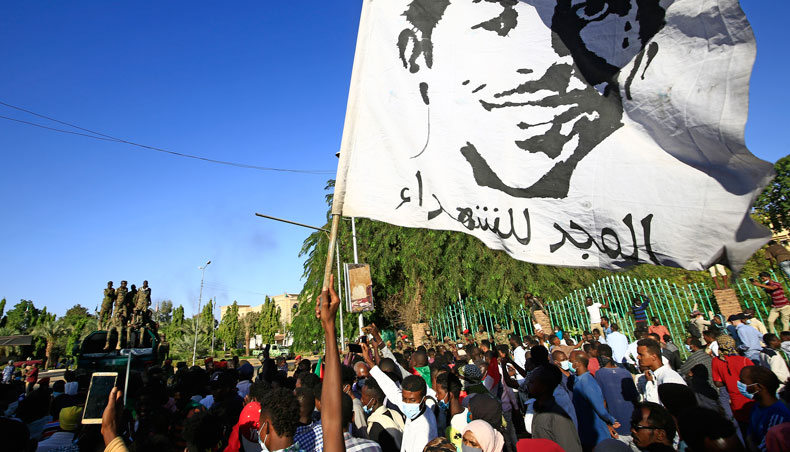 A Sudanese demonstrator waves a banner bearing the inscription ‘Glory to the Martyrs’, during protests in the capital Khartoum, to mark the second anniversary of the start of a revolt that toppled the previous government, on December 19, 2020. — AFP photo