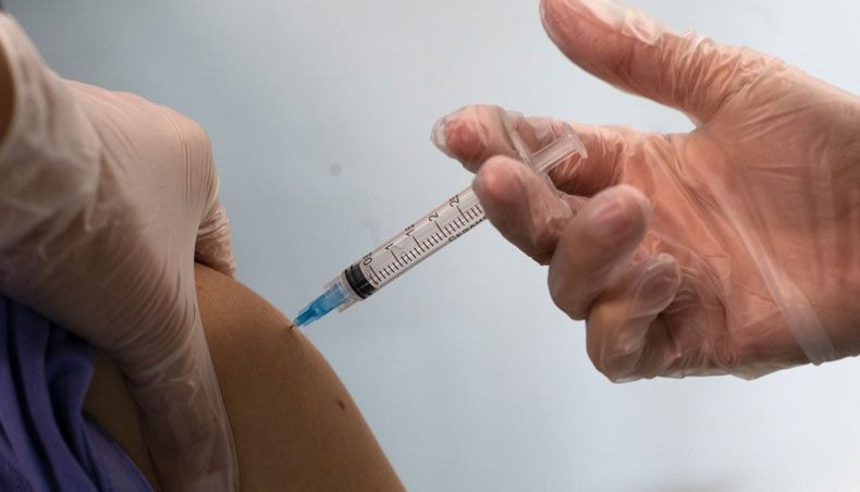 A medical worker receives the Pfizer or BioNTech CoOVID-19 vaccine jab at Hospital Posta Central in Santiago, on December 24, 2020. -- AFP photo