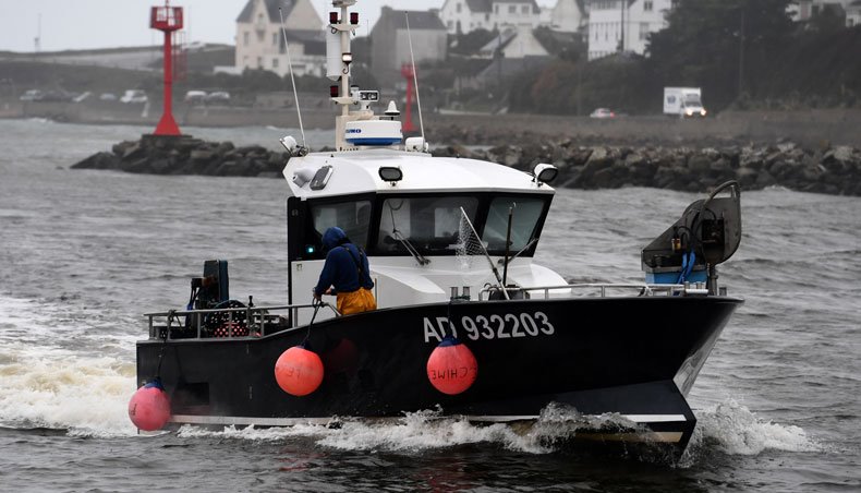 A fishing boat enters the port of Audierne, Brittany, on December 22, 2020 as some 50 fishermen protest against French trawlers practises which are, they say, a waste and a plunder of fish resources. — AFP photo
