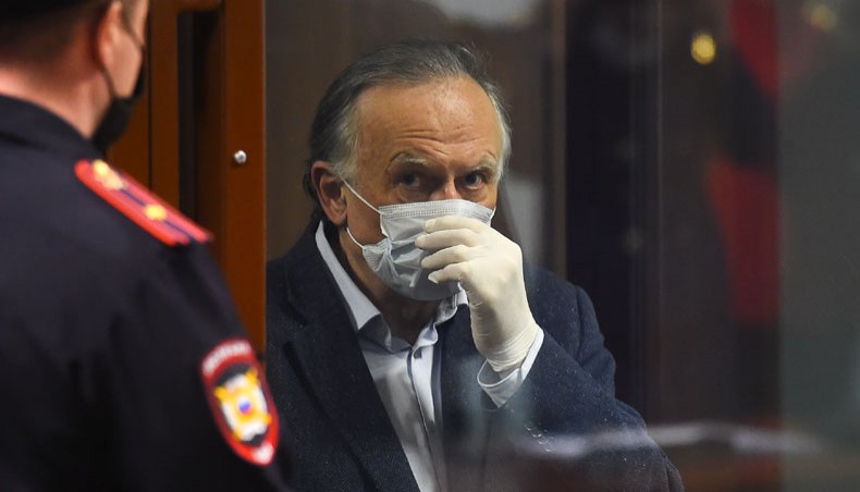 Russian historian Oleg Sokolov, accused of murdering and dismembering his former student lover, stands inside a defendants’ cage during his verdict hearing in Saint Petersburg on December 25, 2020. — AFP Photo