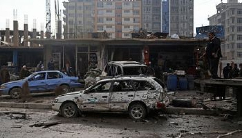 Damaged cars are seen at the site of an attack in Kabul on December 20, 2020. — AFP photo