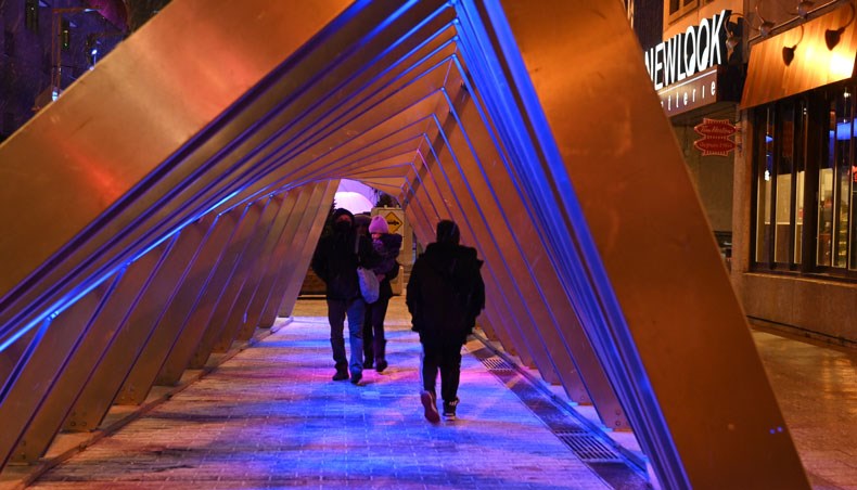 People walk through the ‘Iceberg’ sound-and-light installation on December 18, 2020 in Montreal, Quebec, one of the five light installations on display to bring some comfort to residents of a city that has been battered by months of coronavirus. — AFP photo