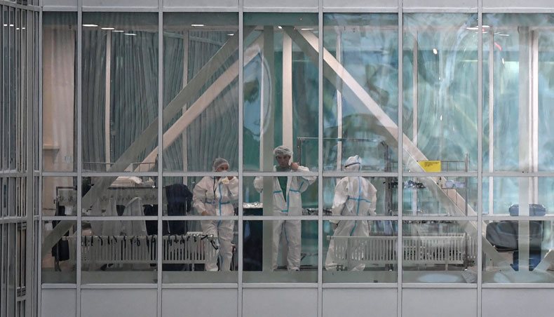 Medical workers are seen in a passageway between the buildings of a hospital in Kommunarka, where patients suffering from the coronavirus disease are treated, on the outskirts of Moscow on December 25, 2020. — AFP photo